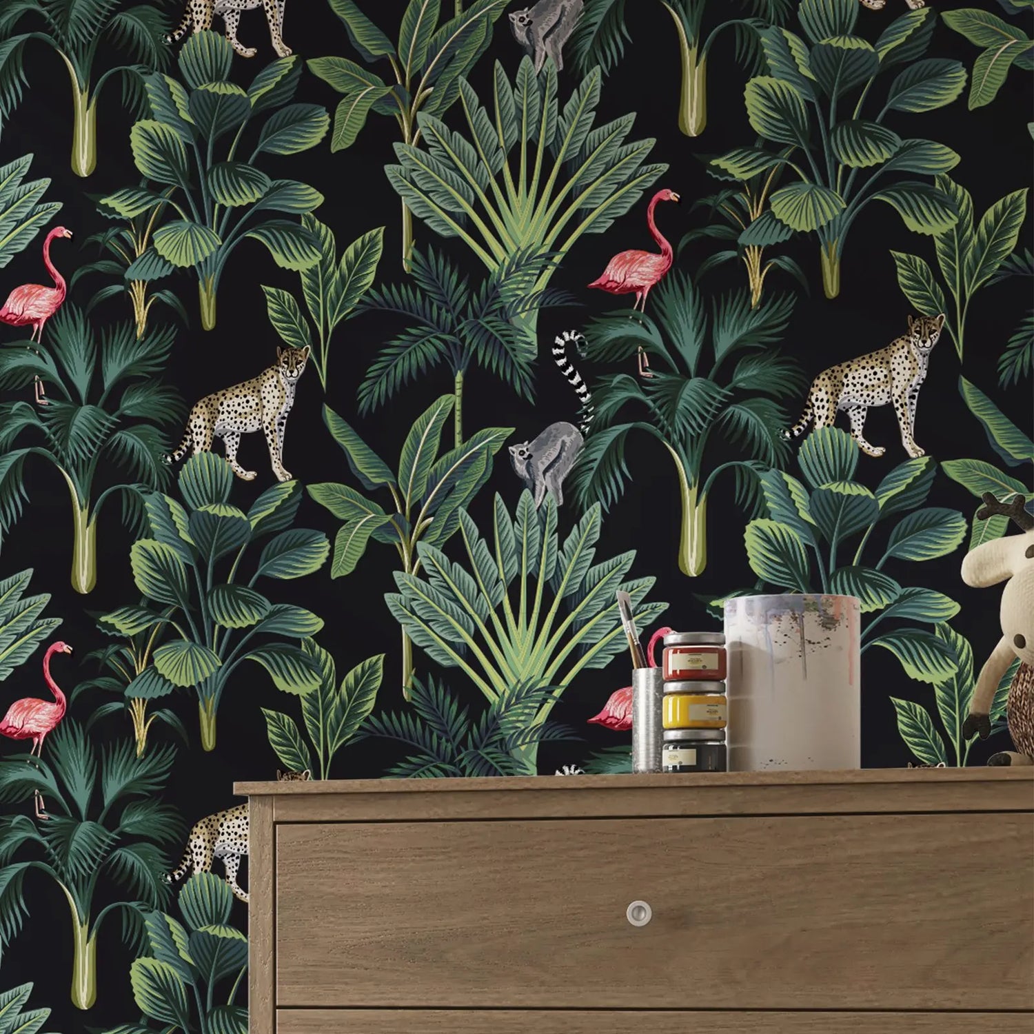Jungle-themed wallpaper with animals and plants on a black background, displayed in a room with a wooden dresser.