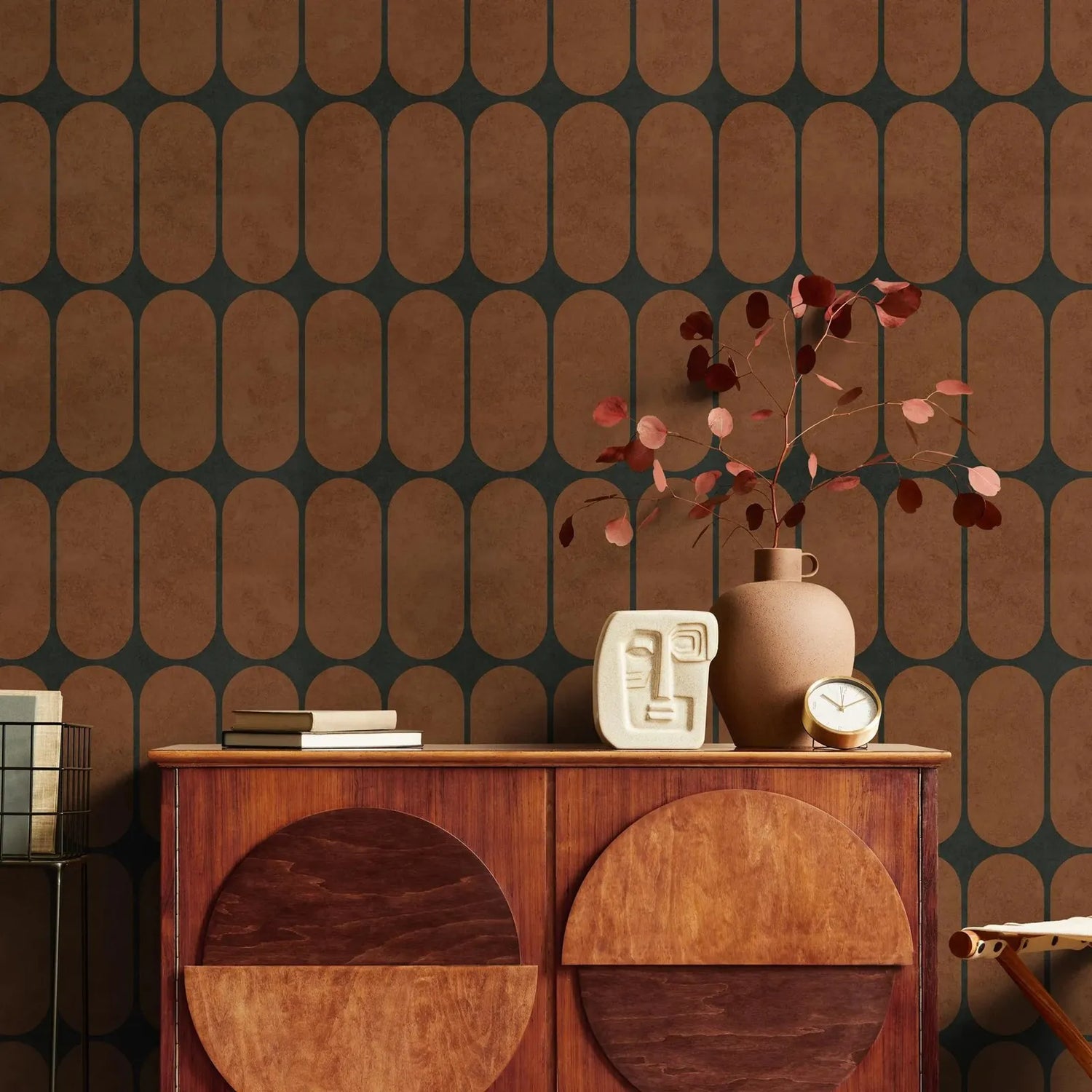 Wooden cabinet with decorative items against a patterned wall.