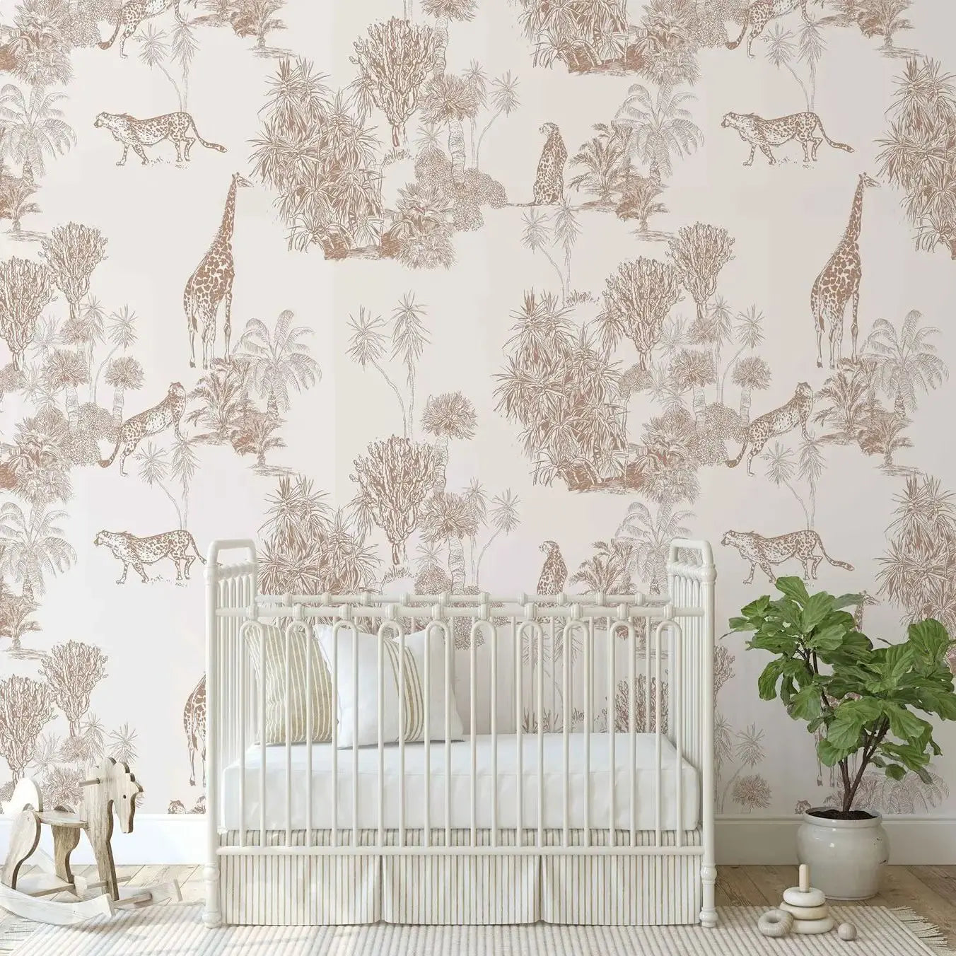 Nursery room with crib and animal-themed wallpaper