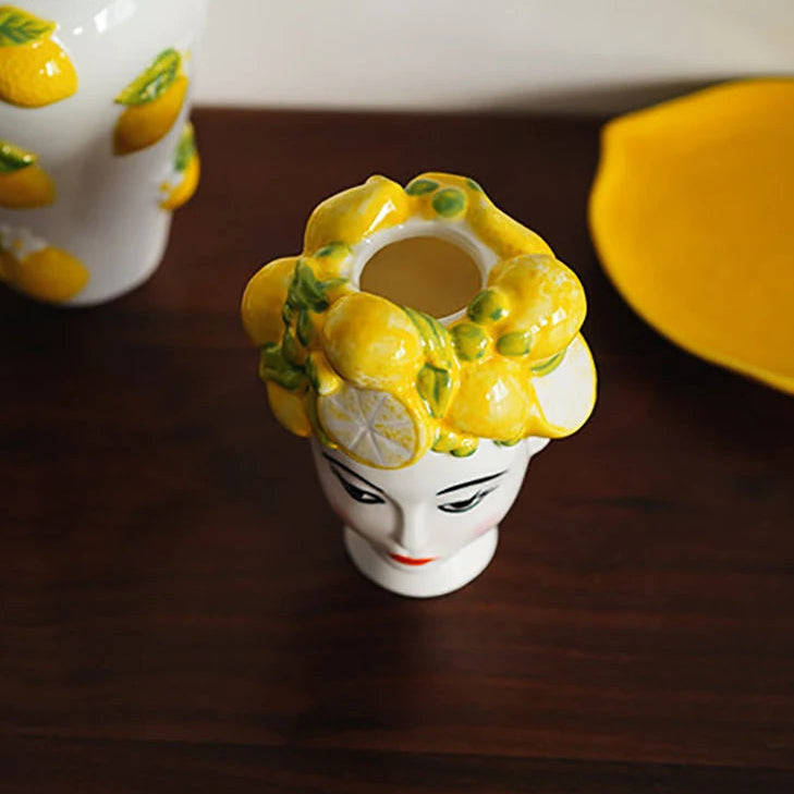 Ceramic figurine with yellow floral design on a dark surface, brand 'ZIZI Fish' visible.