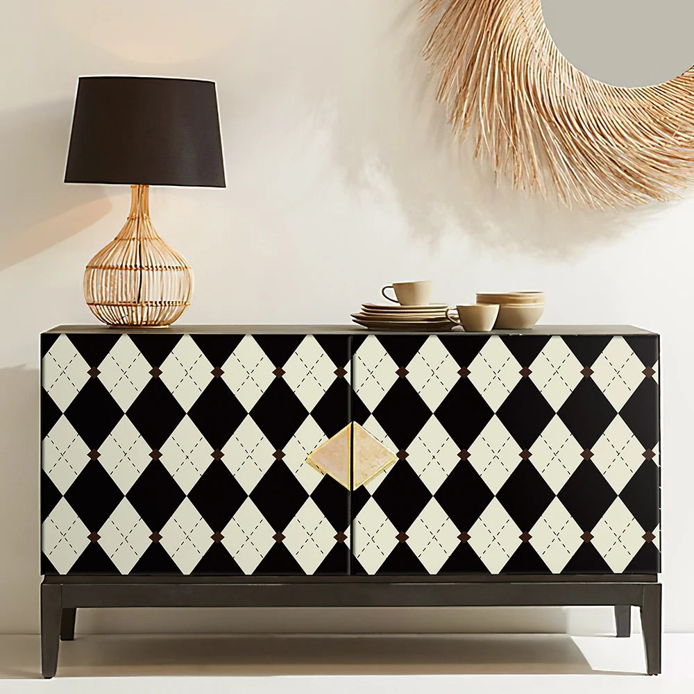 Black and white patterned sideboard with a lamp and decorative items in a room.