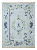 Sky Pavilion Blossom Hand Knotted Rug — light blue, navy, green chinoiserie rug by Maia Homes on a white background