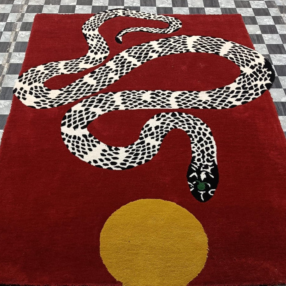Red rug with a snake design on a checkered floor