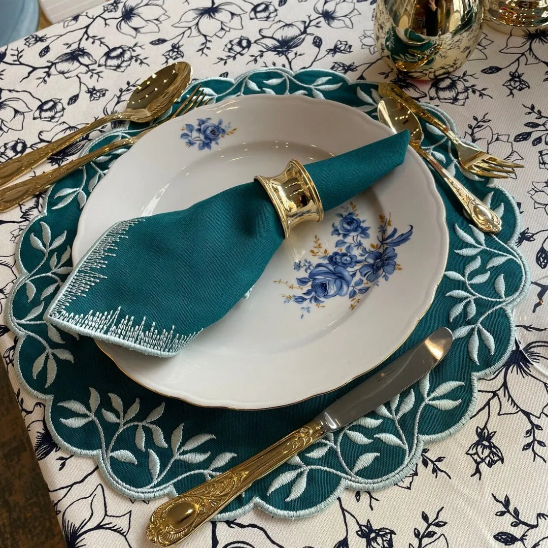 Teal Treasure Placemats, showcasing a stunning teal hue that adds a splash of vibrancy to any table. Crafted for durability and style, these placemats are perfect for casual meals or festive gatherings.