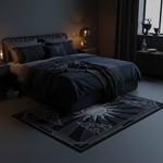 Dark bedroom with a bed and decorative rug featuring a sun design.