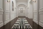Long hallway with a black and white patterned rug on wooden floors.