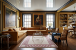 Luxurious living room with a rug, large sectional sofa, coffee table, and decorative elements.