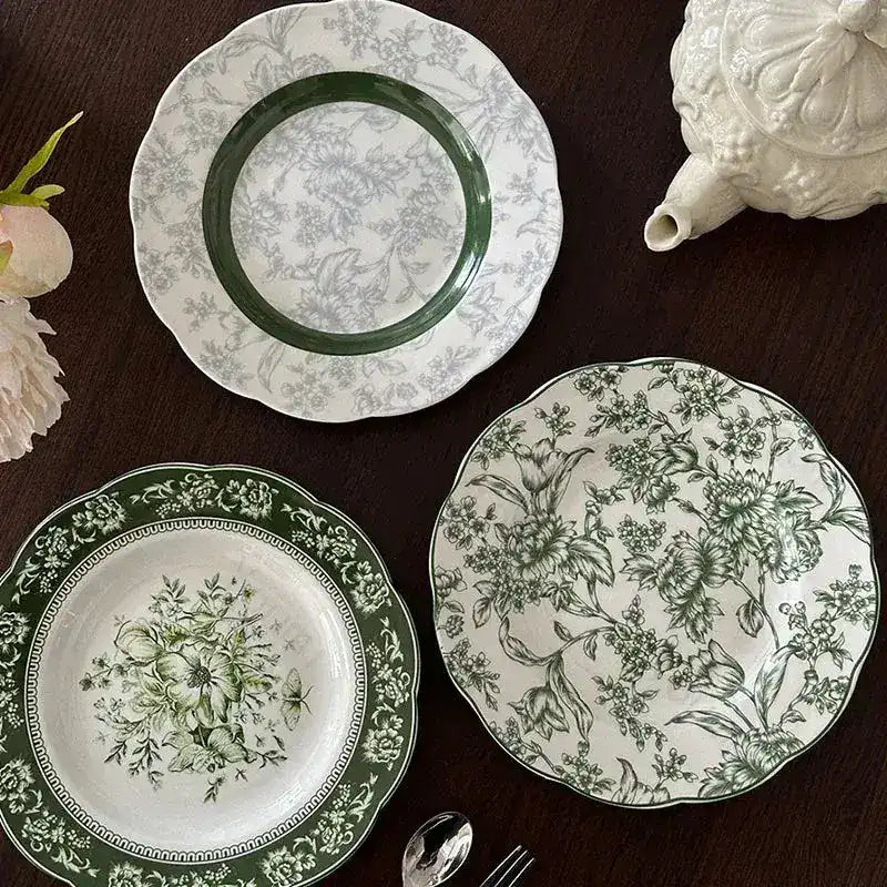 Vintage Inspired Floral Green Plate is a decorative and functional piece of tableware that combines classic charm with timeless elegance. Typically crafted from high-quality ceramic or porcelain, it features intricate floral patterns, often reminiscent of designs popular in the early to mid-20th century. The green base color serves as a soothing backdrop, enhancing the delicate floral motifs, which may include roses, daisies, or other traditional blooms in soft pastel or vibrant hues