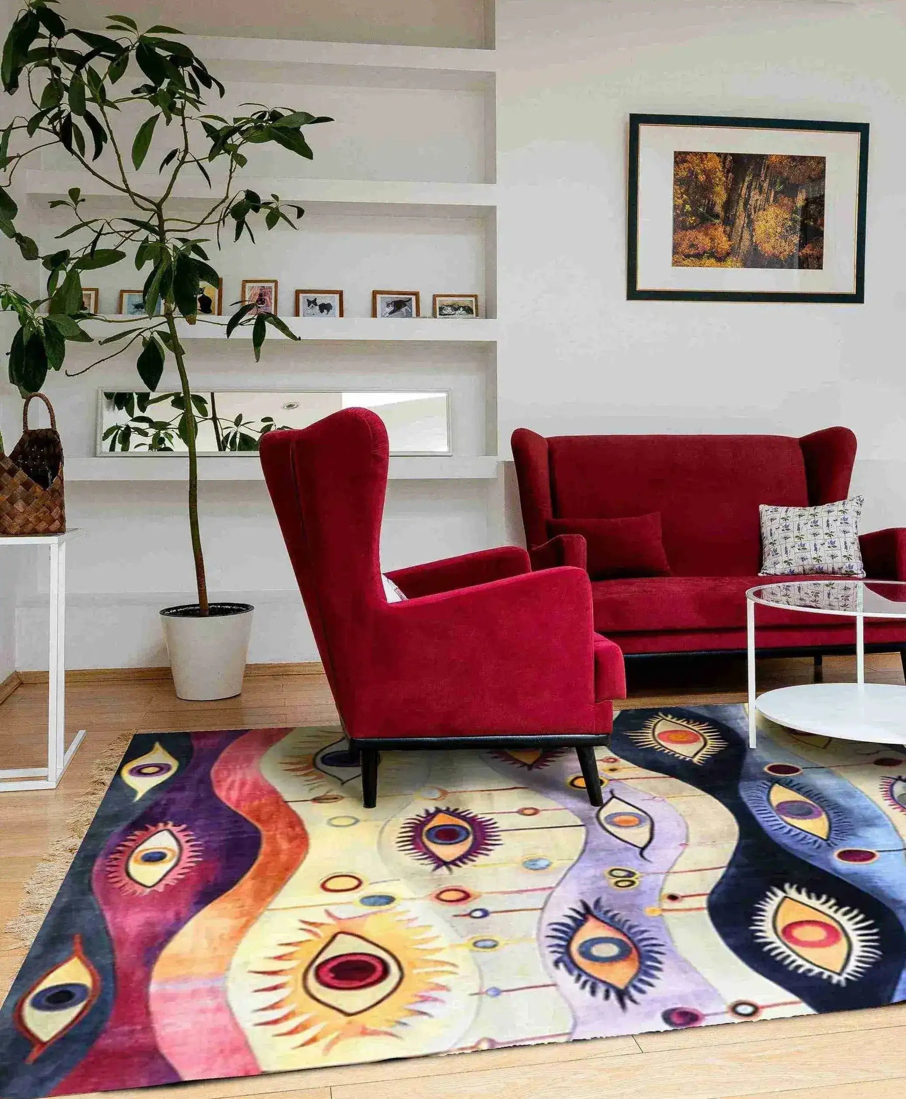 A stunning area rug with an abstract design featuring vibrant eye motifs in a living room setting. The large area rug adds a touch of contemporary style and vintage charm with its colorful pattern. Perfect for those looking for large area rugs for living rooms, this wool rug complements the red armchairs and modern decor, creating a cozy and artistic atmosphere.