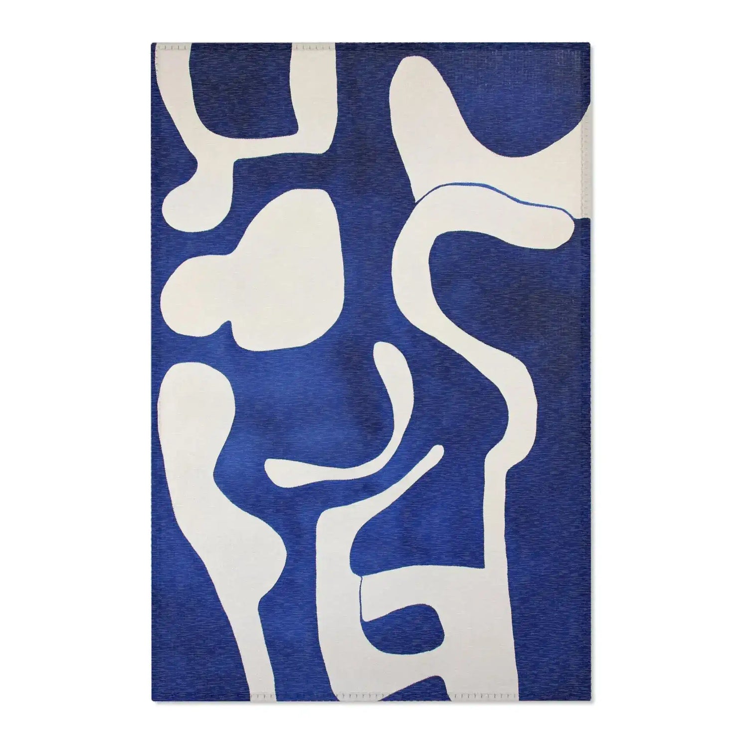 Abstract Blue and White Geometric Rug corner folded showing orange abstract print with organic swirl shapes and grey non-slip backing