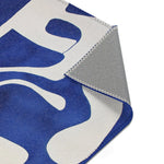 Abstract Blue and White Geometric Rug corner detail folded back revealing cobalt blue and white front and grey non-slip backing