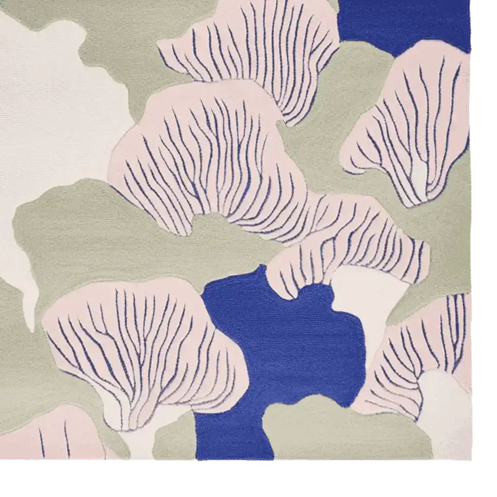 A vibrant Abstract Coastal Bloom Hand Tufted Rug showcasing a contemporary design with organic shapes in soft pink, sage green, and deep blue. This wool area rug, perfect for living rooms, combines modern aesthetics with a cozy feel, enhancing any space with its artistic flair.