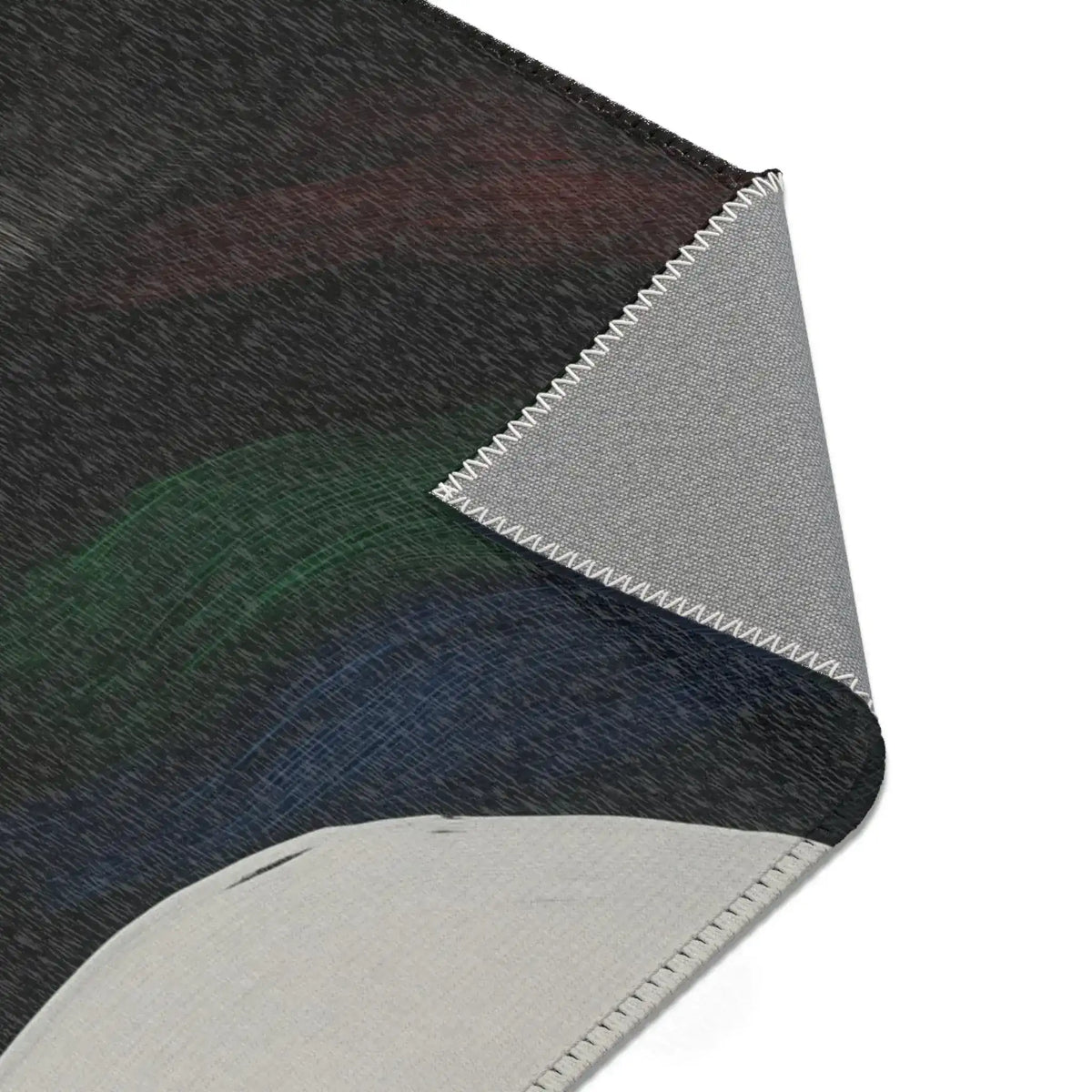 Abstract Duality Flowing Contrast Rug corner folded back revealing grey non-slip backing with zig-zag overlock edge stitching — dark charcoal surface