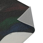 Abstract Duality Flowing Contrast Rug corner folded back revealing grey non-slip backing with zig-zag overlock edge stitching — dark charcoal surface