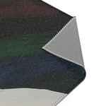 Abstract Duality Flowing Contrast Rug corner detail showing rolled dark print surface and grey backing with overlock seam and dark navy lower section