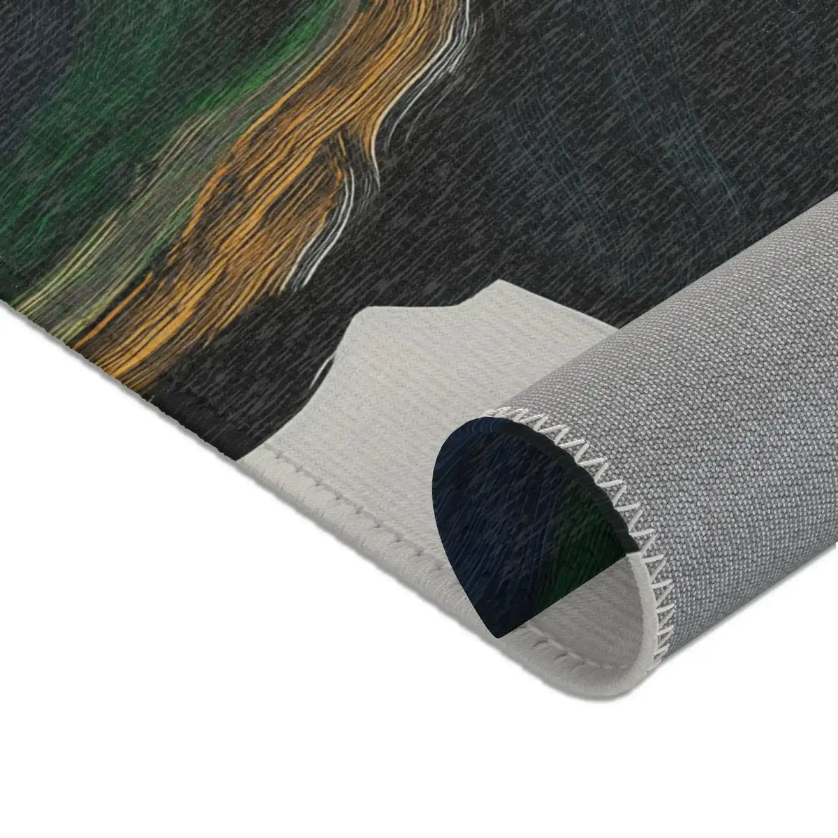 Close-up top corner of Abstract Duality Flowing Contrast Rug showing dark print surface with gold brushstroke and grey zig-zag stitched backing