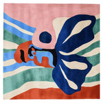 A vibrant, hand-tufted abstract face canvas wool rug, featuring bold colors and dynamic shapes. Ideal as a contemporary square area rug, perfect for adding a touch of modern art to your living room area rugs collection.