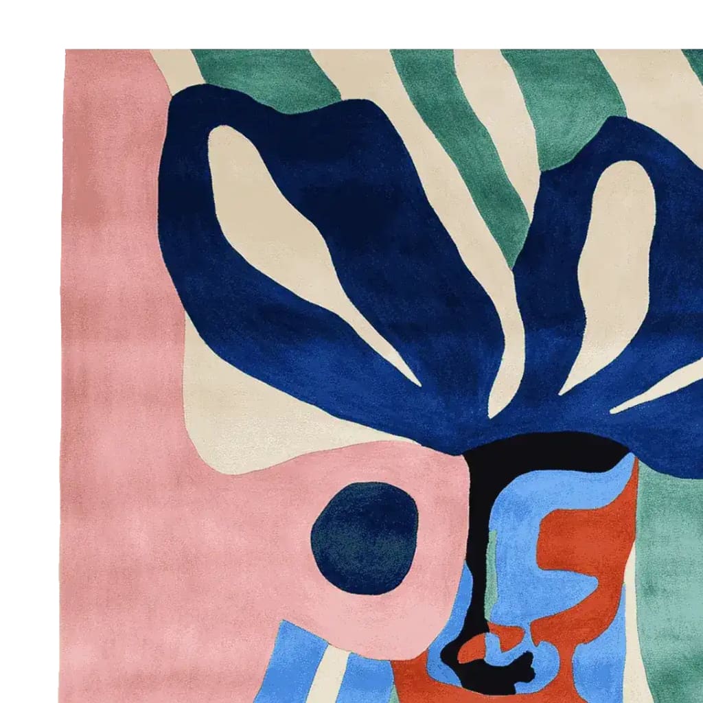 Vibrant abstract face design on a hand-tufted wool rug, featuring bold colors like blue, pink, and green. This contemporary square area rug is perfect for adding a splash of modern art to your living room.