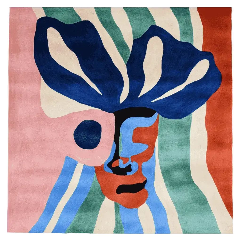 Top view of a colorful, abstract face design on a hand-tufted wool area rug, perfect for contemporary living room decor. This square rug features vibrant blue, green, pink, and red hues, ideal for those seeking a modern square area rug.