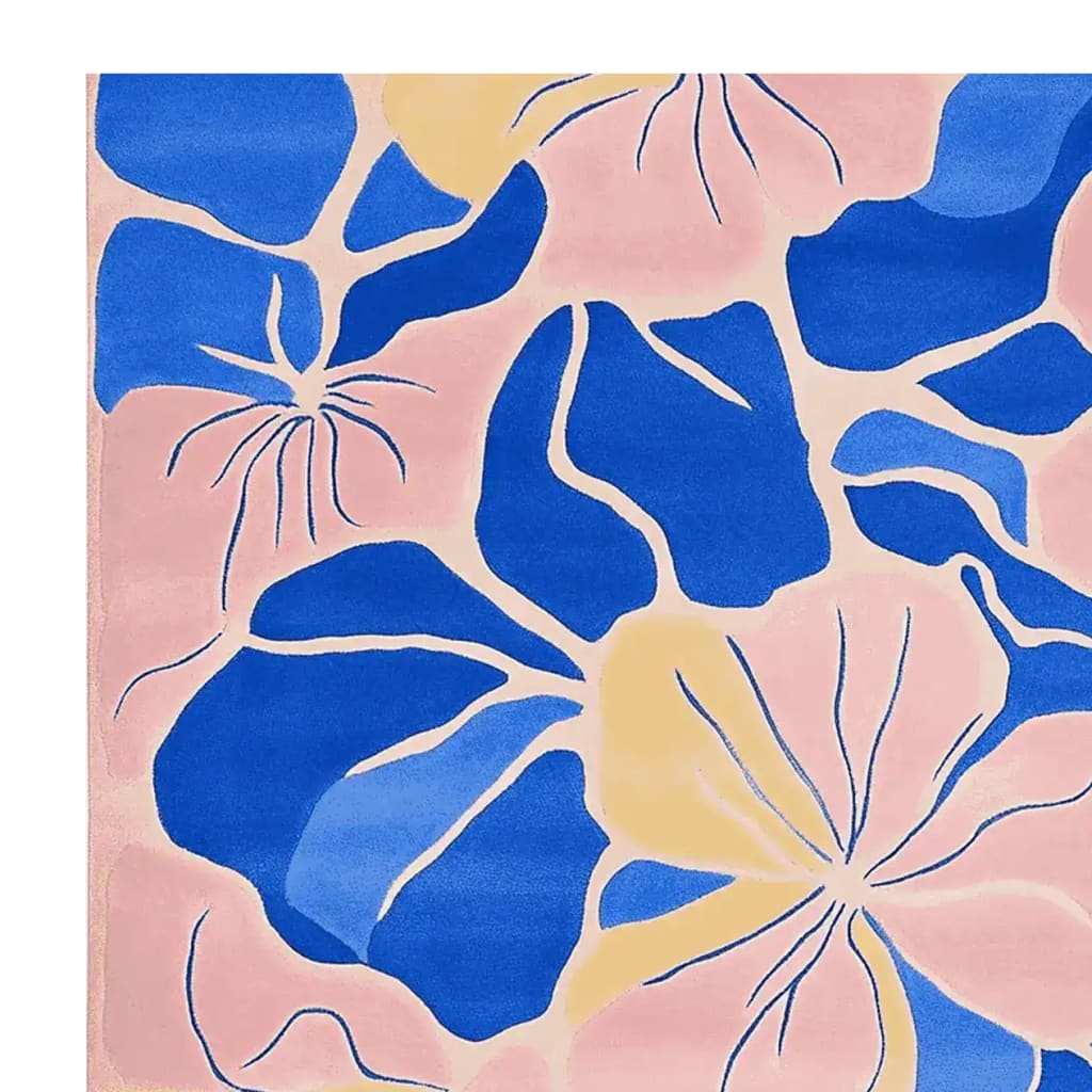 Bright and colorful hand-tufted area rug featuring an abstract floral bloom design with vibrant blue, yellow, and pink hues.