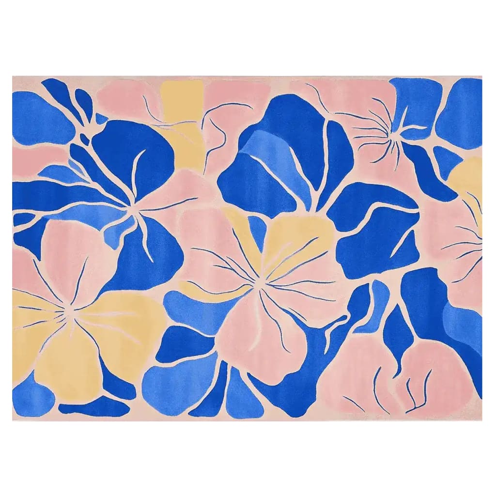 A vibrant Abstract Floral Bloom hand tufted area rug featuring a bold design with large blue and yellow floral patterns on a soft pink background, perfect for adding a splash of color to any room.