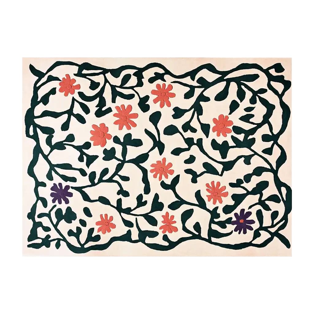 A vibrant hand-tufted wool area rug featuring an abstract floral meadow design. The rug displays red and purple flowers intertwined with dark green vines on a light background, creating a lively and artistic appearance.