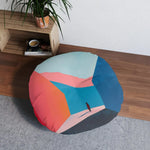 Abstract Geometric Color Block Floor Pillow on gray rug next to wooden shelving, in-room lifestyle larger view