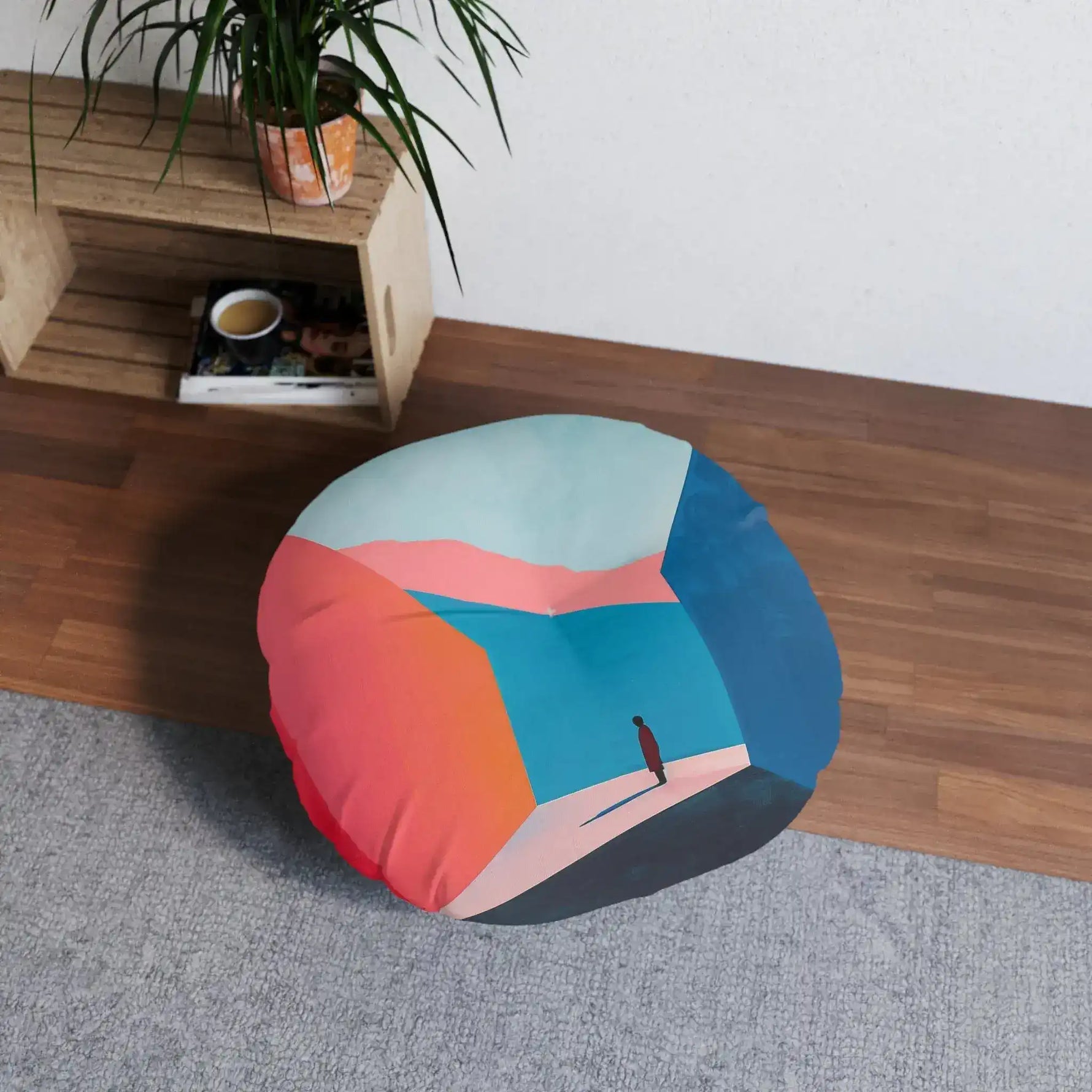 Abstract Geometric Color Block Floor Pillow on wood floor next to wooden shelving unit with plant, in-room lifestyle view