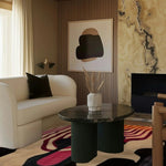 Stylishly designed living room featuring an abstract ink blot hand-tufted area rug with vibrant colors, perfect for adding a creative touch to dining room carpets or living room area rugs. The wool rug complements the modern decor with a cozy sofa, elegant artwork, and a sleek coffee table.