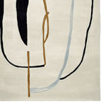 Top view of an abstract line story hand-tufted area rug, showcasing a contemporary design with bold black, brown, and light blue lines on a cream background. Perfect for large living room spaces, this wool rug adds a modern touch to any decor.