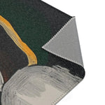 Abstract Noir Portrait Rug angled corner view showing gold curved line on dark green background, grey backing exposed