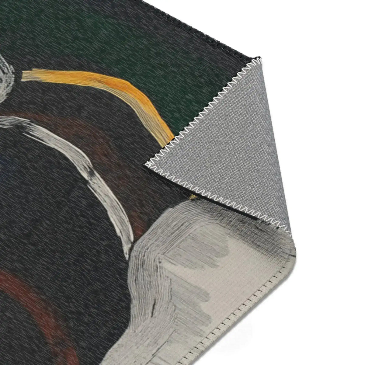 Abstract Noir Portrait Rug corner fold showing dark green-black face with gold arc detail, grey non-slip backing visible