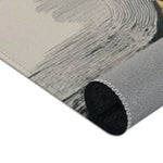 Abstract Noir Portrait Rug rolled corner view showing pale grey brushstroke area with dark tube curl, backing detail