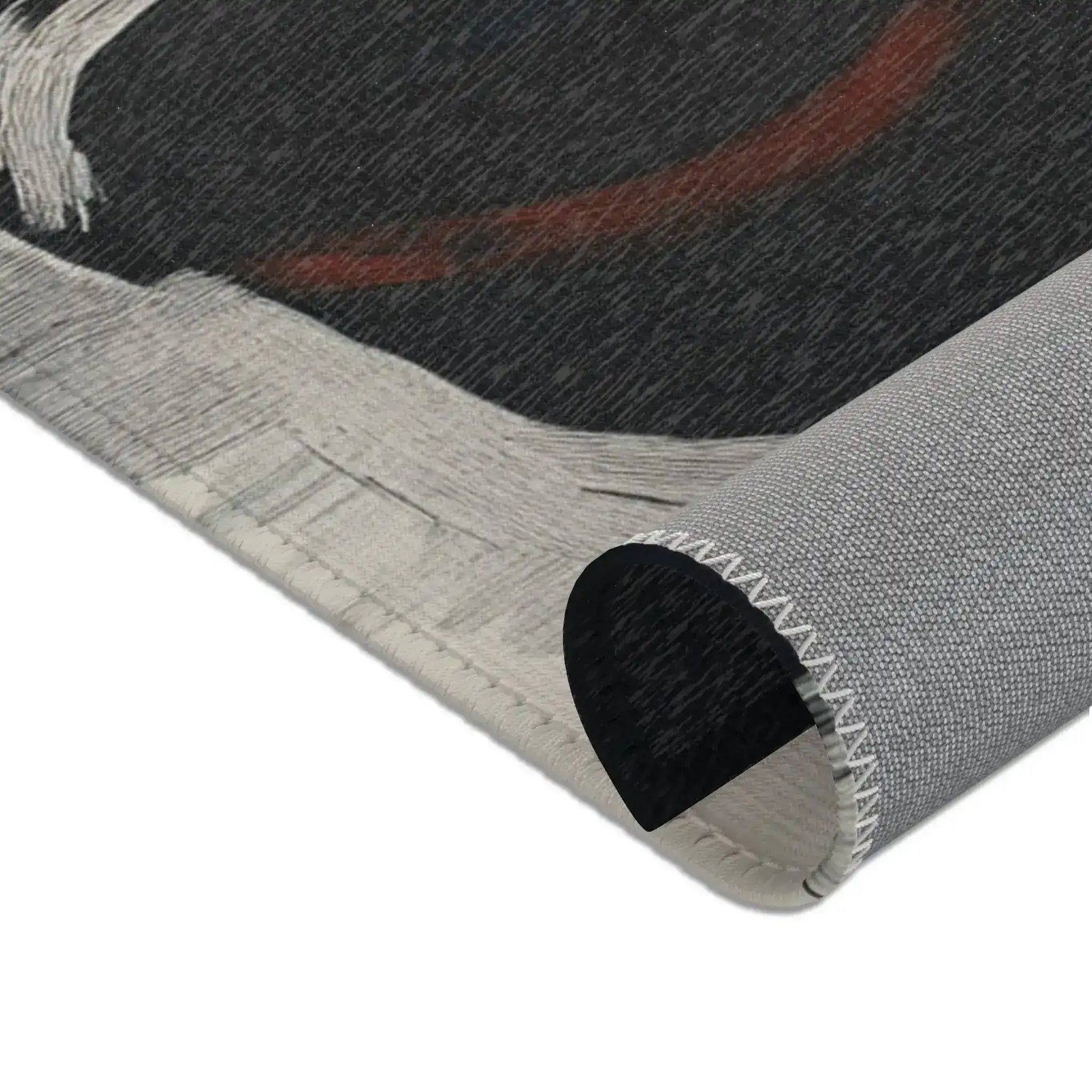 Abstract Noir Portrait Rug rolled edge close-up showing white-grey brushstroke border and red-brown arc detail, grey backing