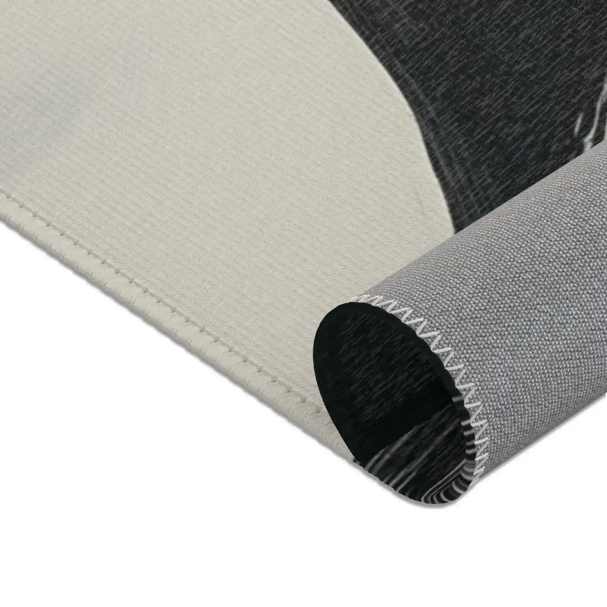 Abstract Noir Striped Elegance Rug backing close-up — large ivory face panel with grey woven underside and dark charcoal pile at upper edge
