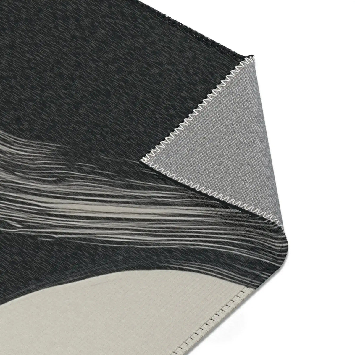 Abstract Noir Striped Elegance Rug wave stripe corner — charcoal pile with sweeping white horizontal lines near edge, backing fold shown