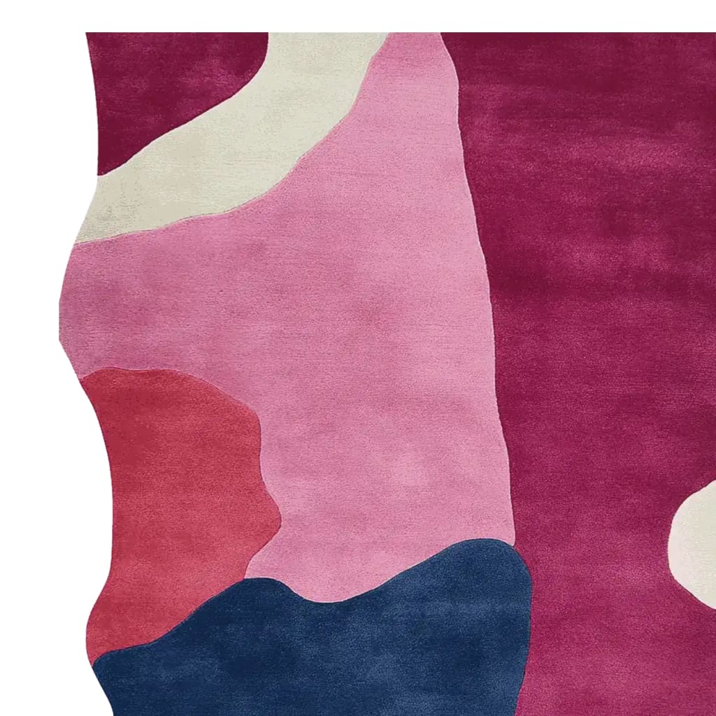 A vibrant area rug featuring an abstract design with bold colors like pink, red, navy, and cream. This contemporary wool rug is perfect for adding a touch of modern art to your living room decor, making it a standout piece among area rugs for living room settings.