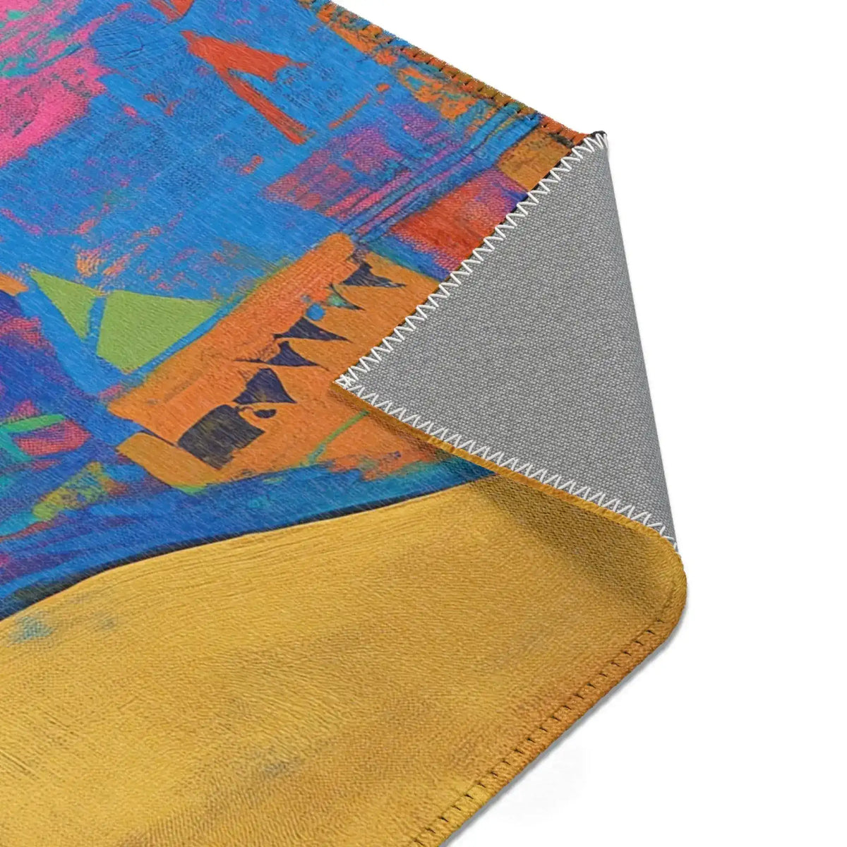 Folded corner of Abstract Silhouette Rug displaying ornate red and gold arabesque scrollwork pattern, grey non-slip backing visible at edge