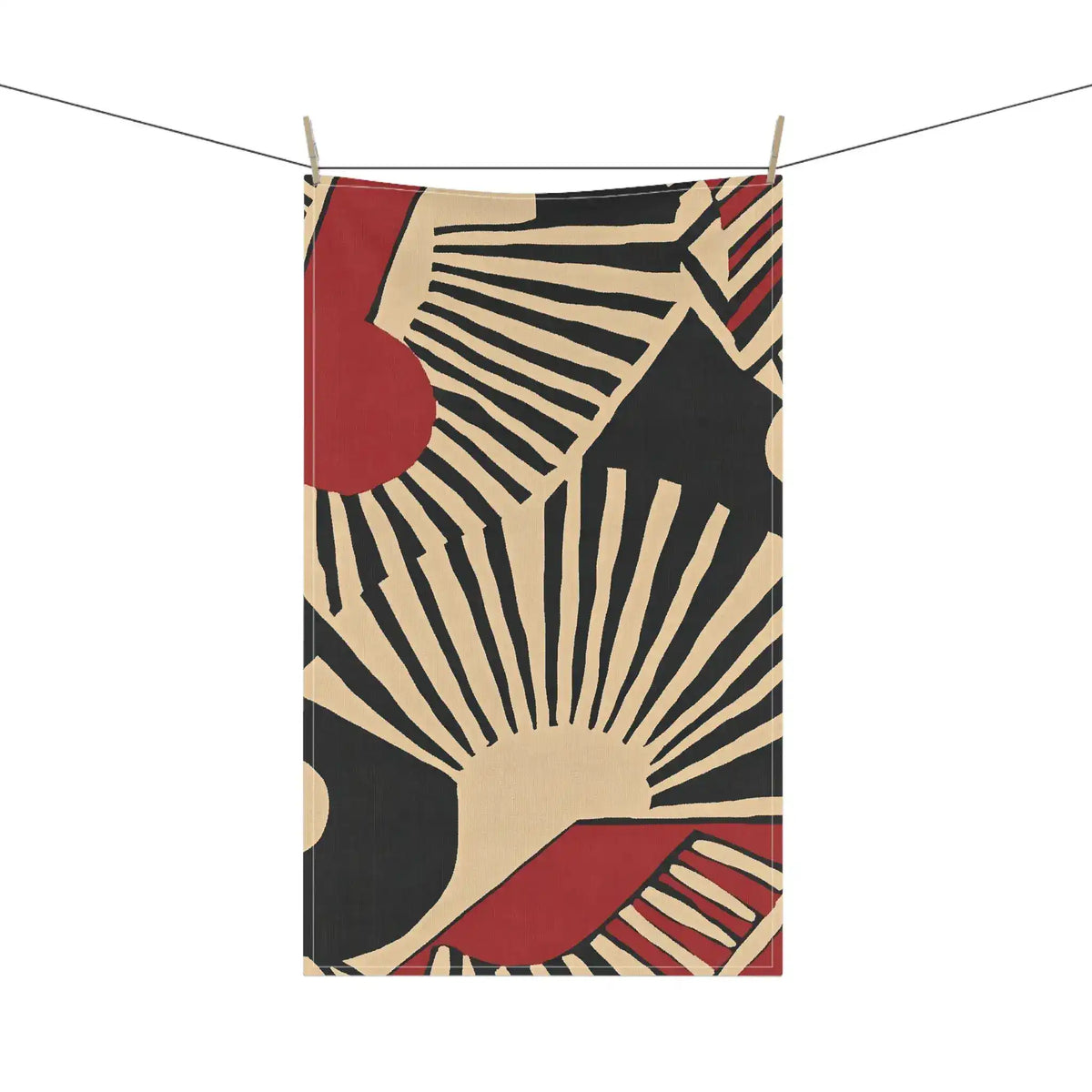 Abstract Sunburst Cotton Kitchen Towel hanging on clothesline — bold cream-black sunburst and deep red shapes design, portrait view