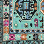 Close-up view of the Alaia Persian Turquoise Melting Area Rug showcasing intricate patterns and vibrant colors. This wool rug is perfect for large area rug settings in living rooms or offices, combining traditional motifs with a modern twist.