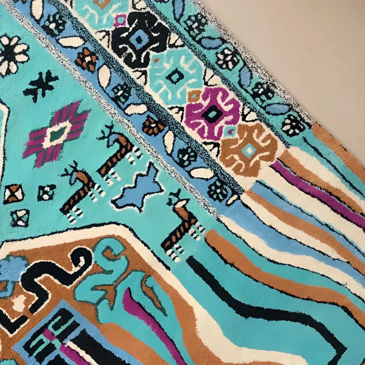 Close-up of the Alaia Persian Turquoise Melting Area Rug showcasing its intricate patterns and vibrant colors. This large wool rug is perfect for adding a stylish touch to your living room or office.
