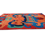 Angled Monarch of the Mountains rug, red field with orange motifs, blue swirls and teal accents
