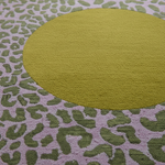 Green circular rug on a patterned surface