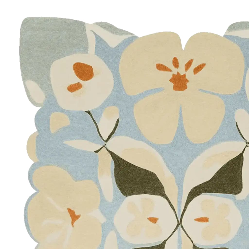 A close-up view of the Art Bloom Reverie Hand Tufted Rug showcasing its contemporary floral design with shades of cream and orange against a soft blue background. This elegant wool area rug is perfect for adding a touch of sophistication to living room spaces, enhancing the ambiance with its unique pattern.
