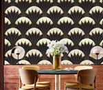 Art Deco black gold wallpaper in dining setting with dark table, yellow chairs, gold vase, white flowers, globe lamps