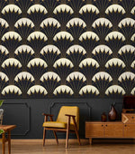 Art Deco black gold wallpaper above dark grey paneled wall with yellow armchair, wood credenza, brown vases in retro room