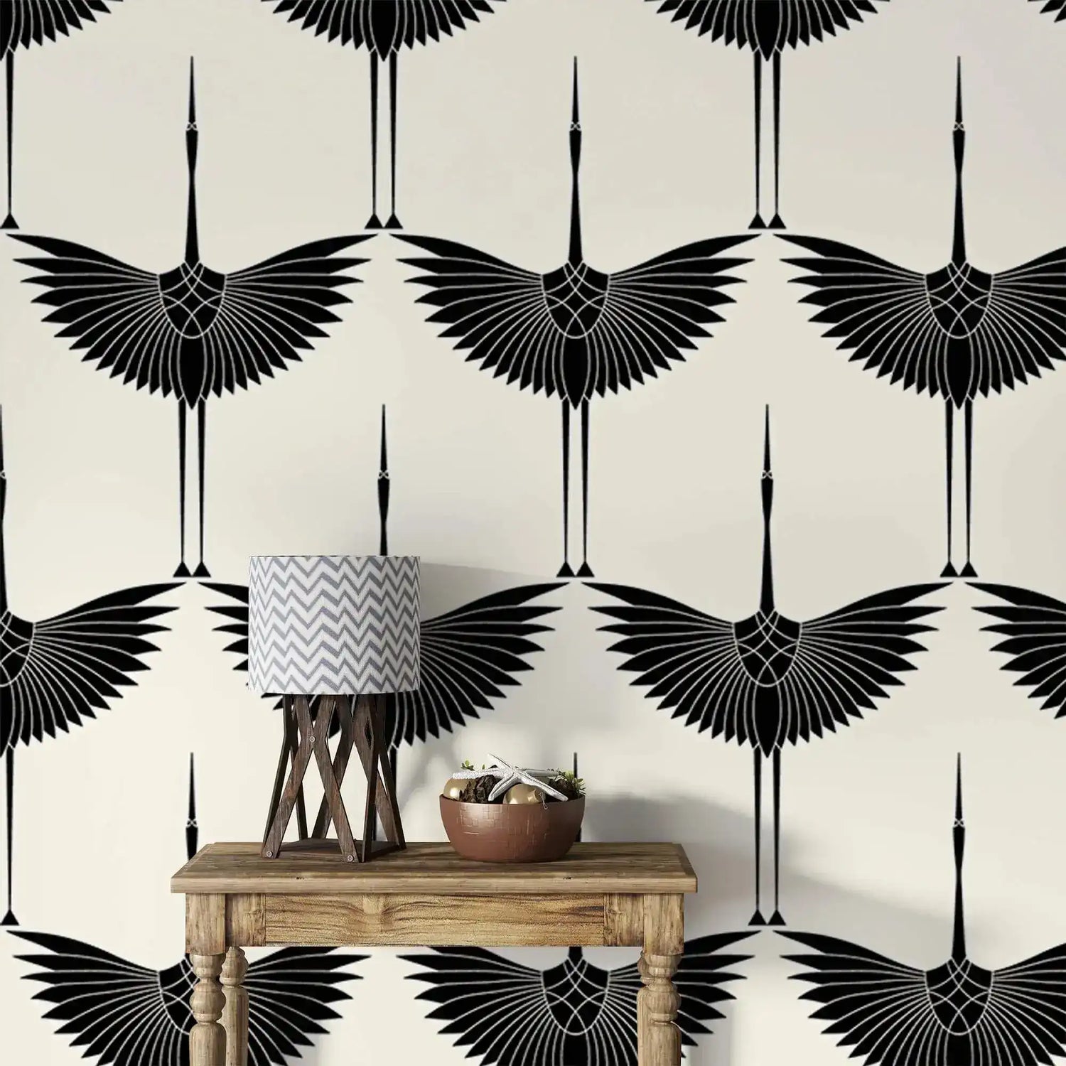 Art Deco Black Heron crane wallpaper, wings outstretched on ivory, behind a wood console and lamp