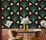 Art deco greenery fan-leaf wallpaper behind dark dining table with wood sideboard and white flower vase