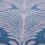 Close-up of a blue and white feather pattern rug