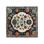 Top view of an Artesian Splendor knotted wool area rug featuring a vibrant floral pattern. This elegant living room area rug showcases a harmonious blend of rich colors including deep teal, warm orange, and cream, creating a luxurious and inviting atmosphere.